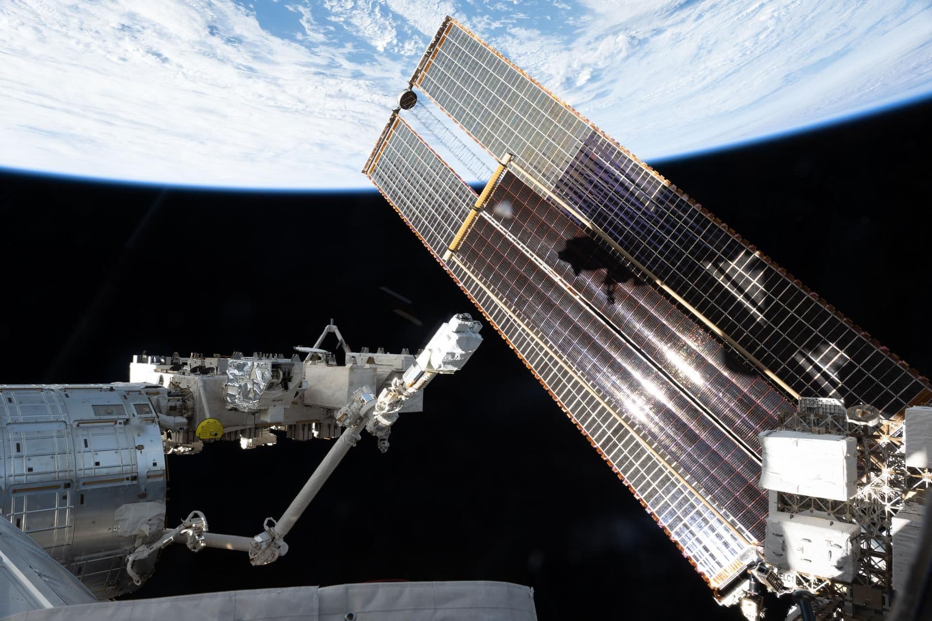 Solar arrays and station hardware in low Earth orbit, with Earth's horizon below